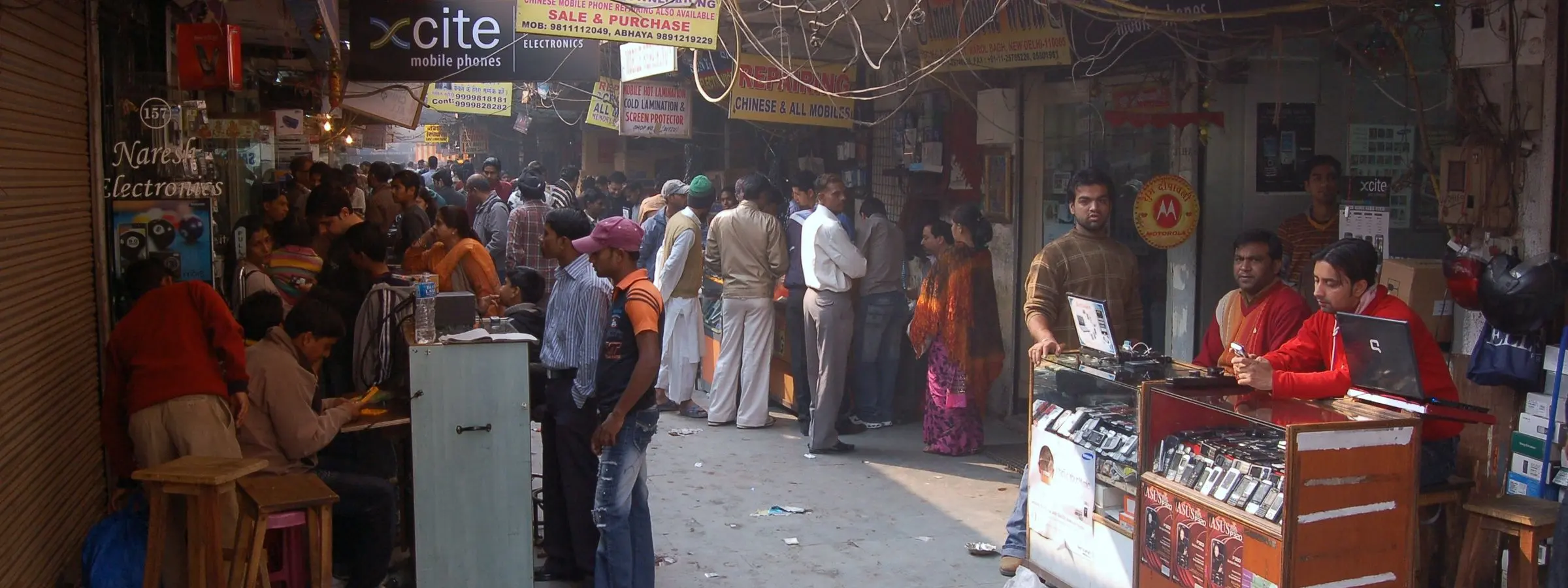 Shops and street stalls along a market lane in Karol Bagh, Delhi, on a working day