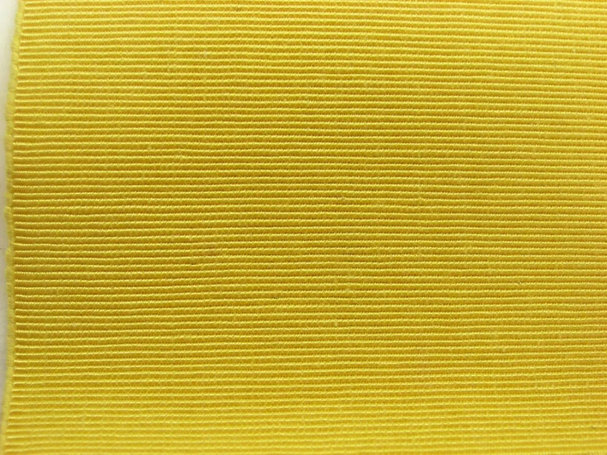 Close view of the weave of a saffron yellow cotton fabric
