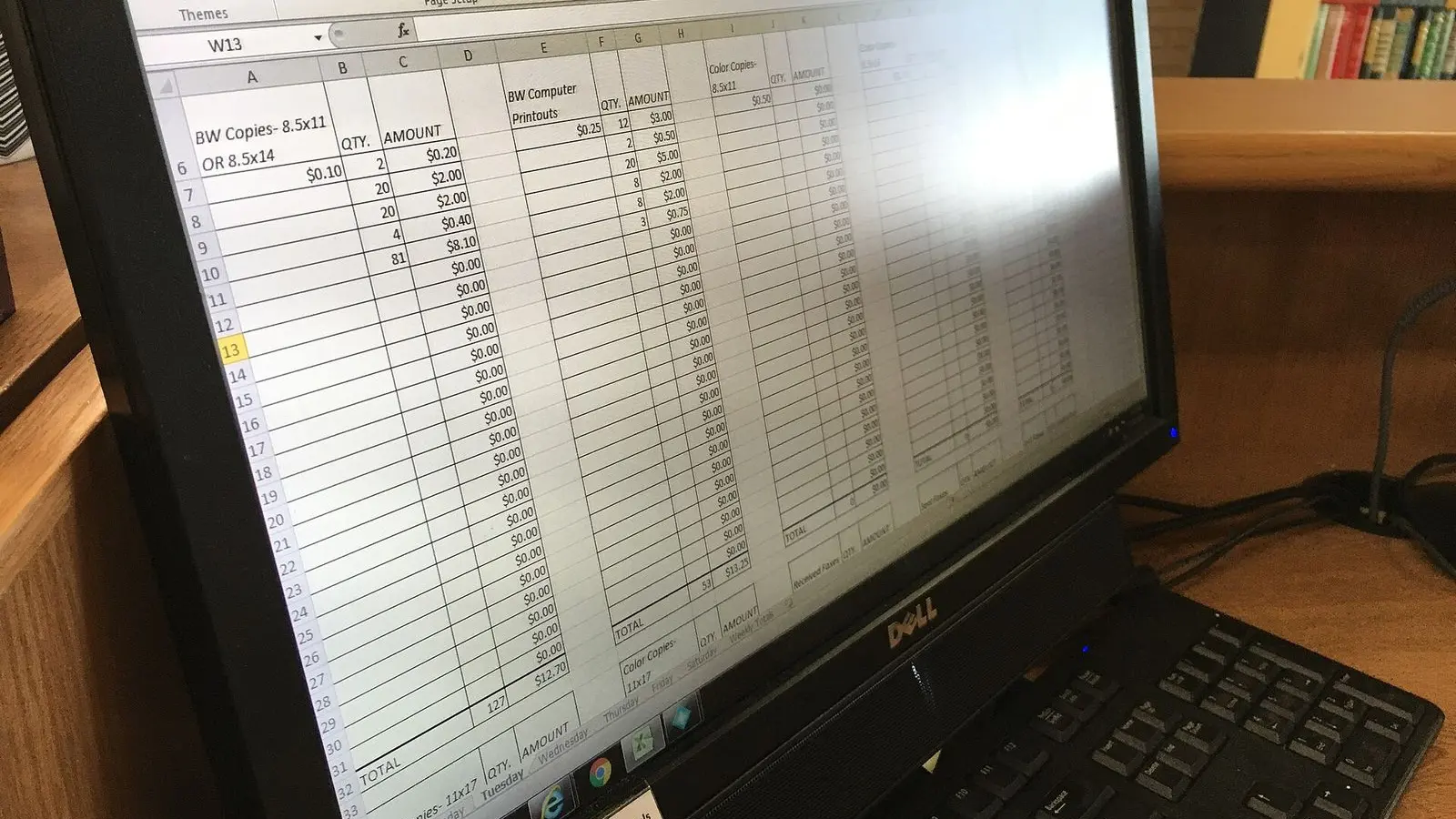 A spreadsheet of rows and columns on a computer monitor, photographed close and at an angle