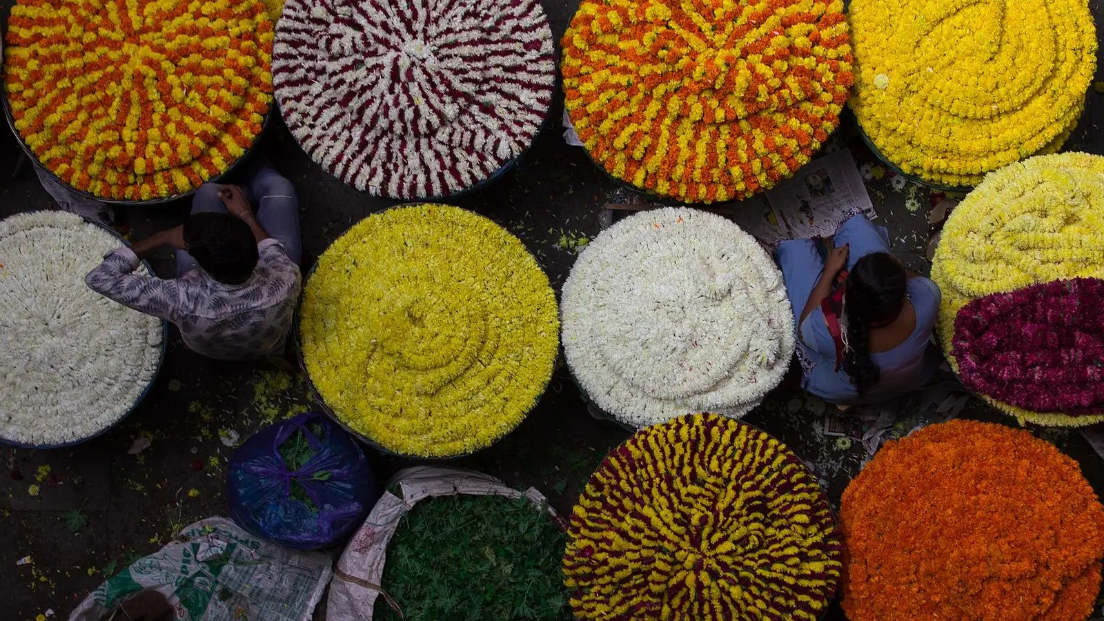 Heaps of marigold and chrysanthemum flowers on sale at City Market, Bengaluru, seen from above