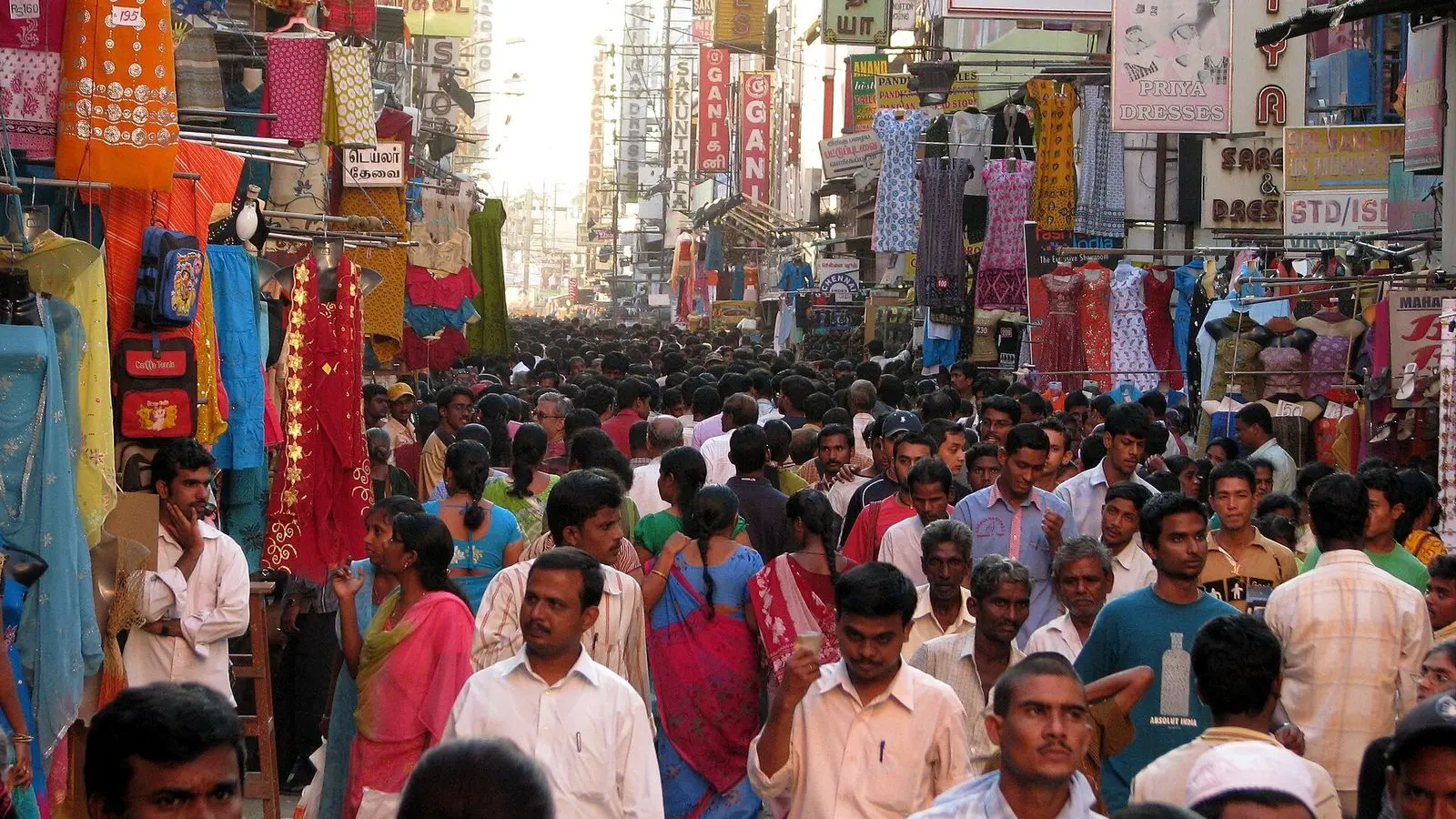 A crowded shopping street in T. Nagar, Chennai, lined with saree and clothing shops