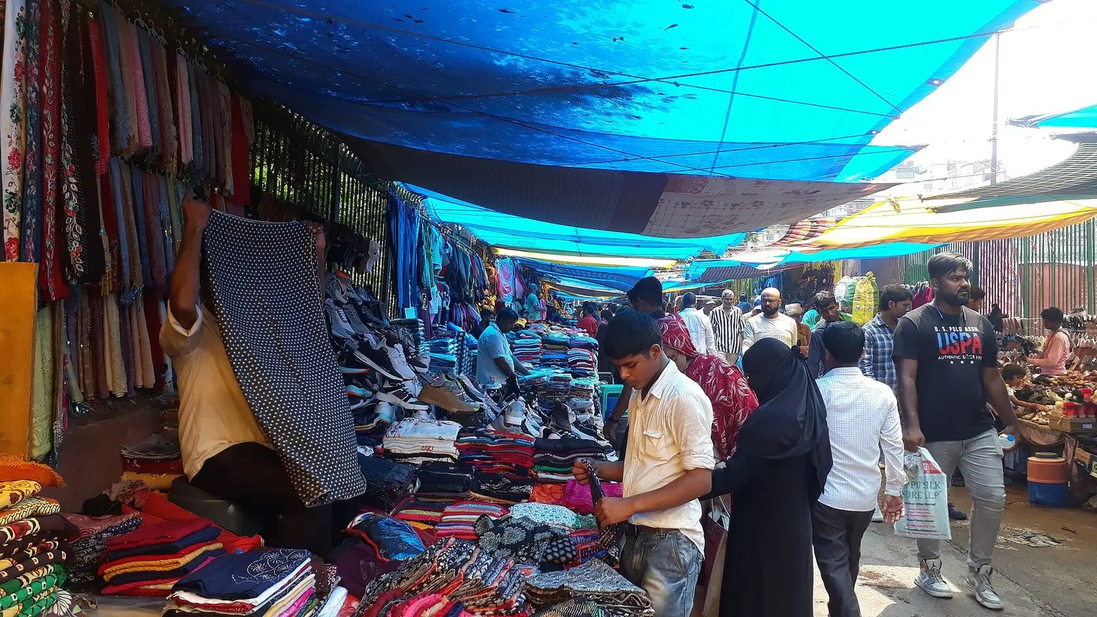 Stalls of fabric and clothing under awnings in Meena Bazar, the market near Jama Masjid in Old Delhi
