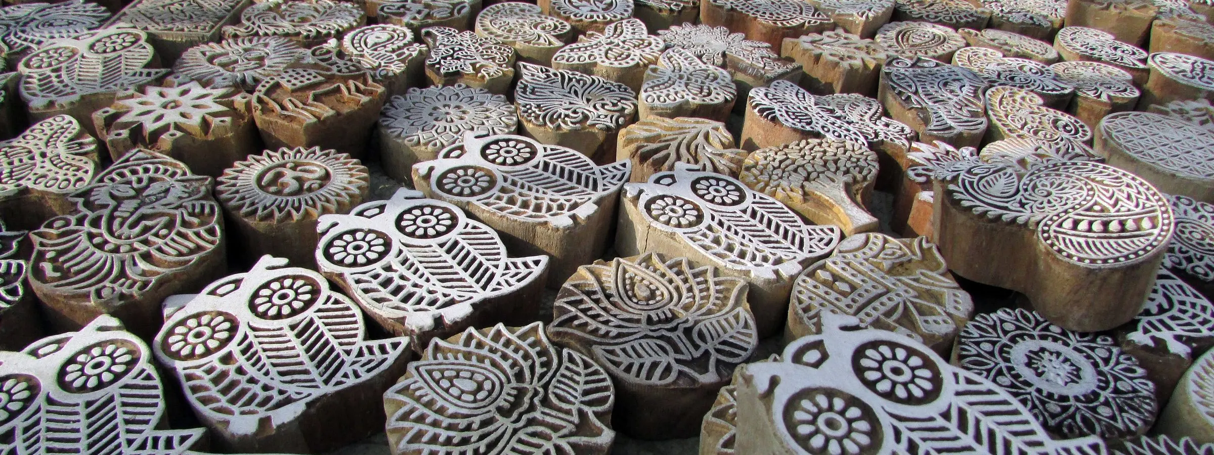 Carved wooden blocks for hand block printing on fabric, laid out in rows