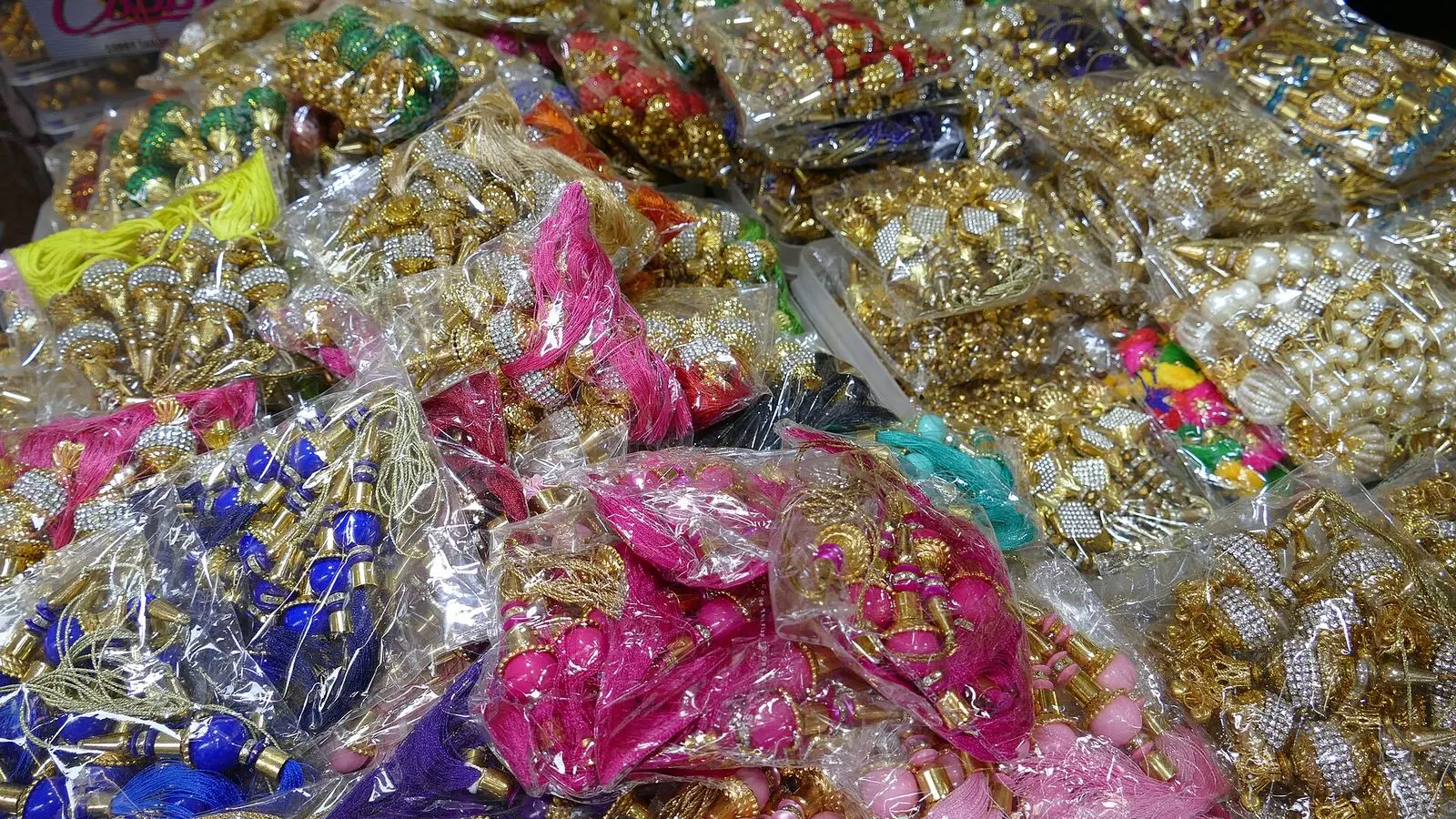 Packets of beaded and silk-thread tassels and garment trims piled on a stall in Burrabazar, Kolkata