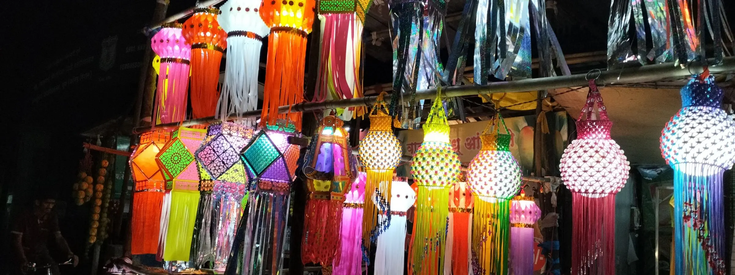 Paper akash kandil lanterns in bright colours hanging for sale at a Pune shop before Diwali