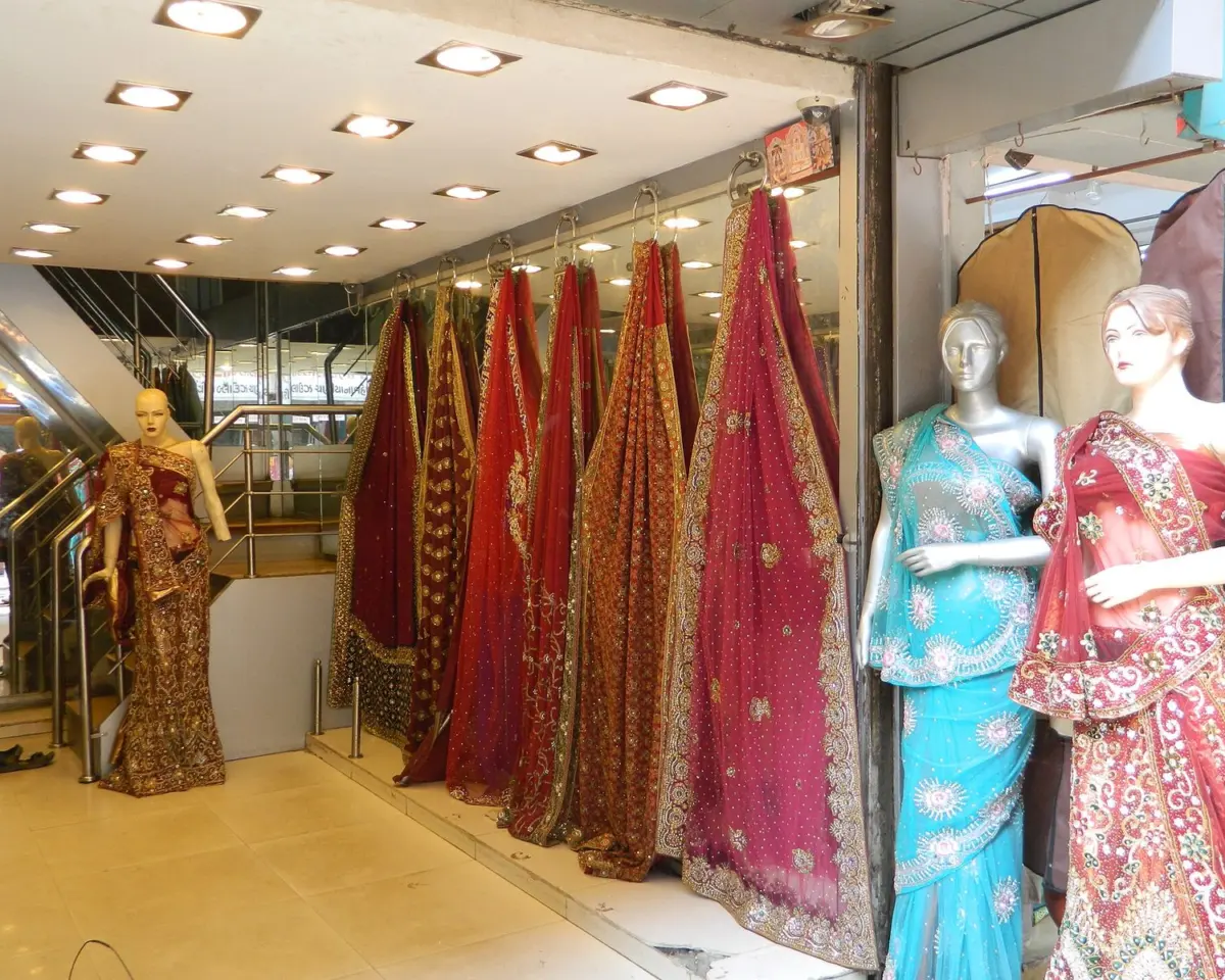 Readymade garments hung and stacked inside a small clothing shop at Ratan Pole, Ahmedabad